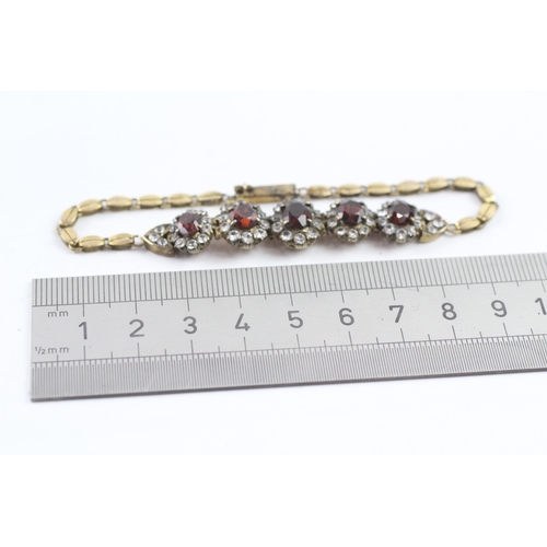 323 - 6ct gold vintage garnet and white sapphire graduated halo bracelet (10.5g)