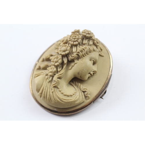 328 - A gold mounted lavastone cameo brooch (24.3g)