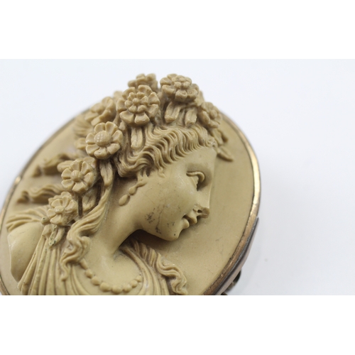 328 - A gold mounted lavastone cameo brooch (24.3g)