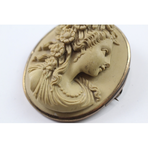 328 - A gold mounted lavastone cameo brooch (24.3g)