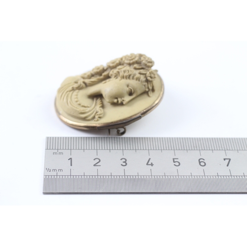 328 - A gold mounted lavastone cameo brooch (24.3g)