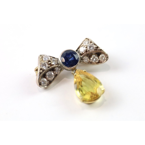 383 - A gold and silver bow brooch set with diamond and yellow and blue sapphires (2.6g)