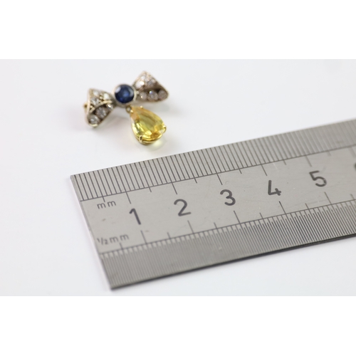 383 - A gold and silver bow brooch set with diamond and yellow and blue sapphires (2.6g)