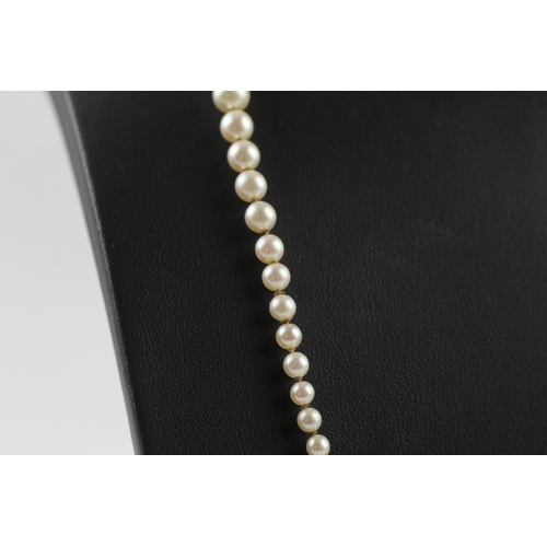 408 - Gold and diamond clasped imitation pearl necklace (11.7g)