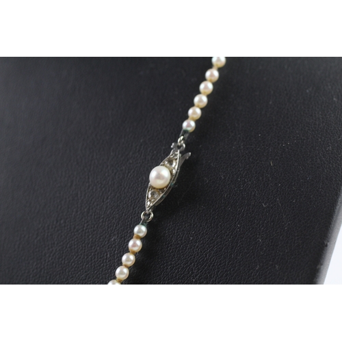 408 - Gold and diamond clasped imitation pearl necklace (11.7g)