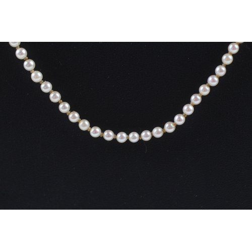 408 - Gold and diamond clasped imitation pearl necklace (11.7g)