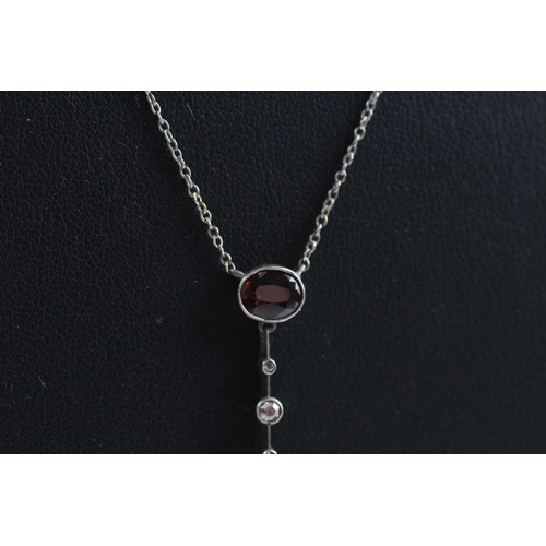 409 - 9ct white gold citrine, garnet and diamond necklace (4g)