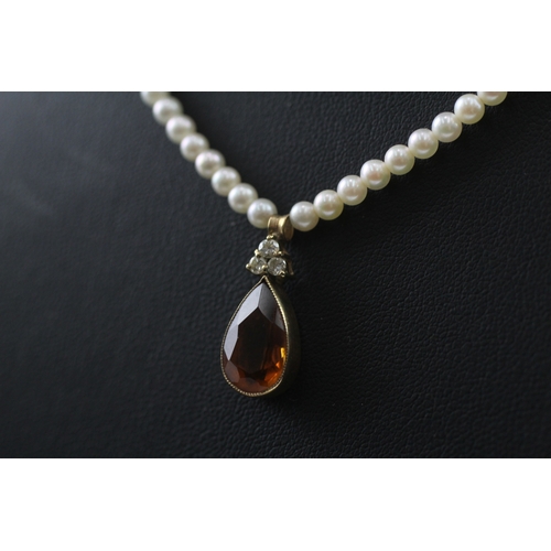 412 - 14ct gold pearl necklace with a diamond and citrine pendant (7.3g)