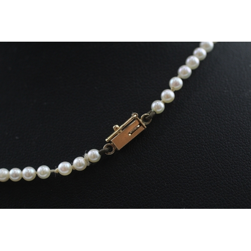 412 - 14ct gold pearl necklace with a diamond and citrine pendant (7.3g)