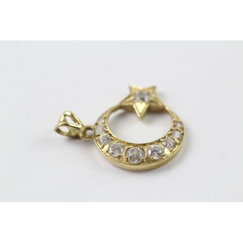 431 - 14ct gold cubic zirconia set moon and star pendant (2.5g)