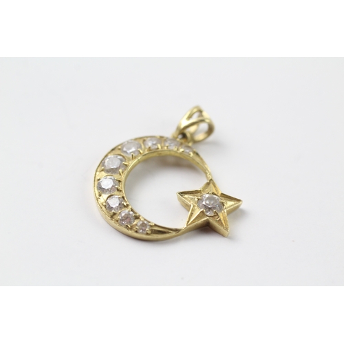 431 - 14ct gold cubic zirconia set moon and star pendant (2.5g)