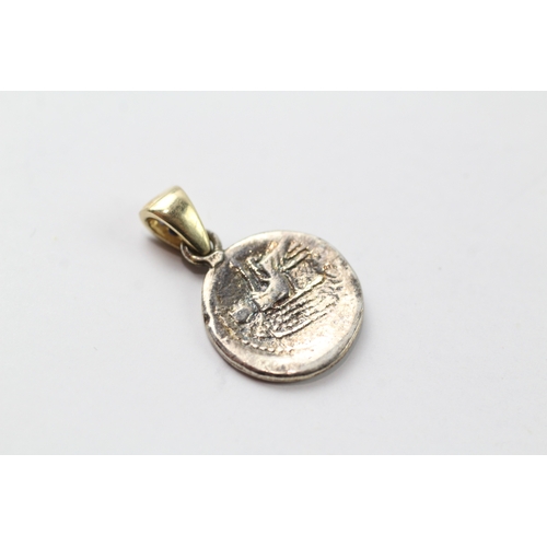 456 - A silver coin mounted with a 9ct gold and sapphire set bail (1.9g)