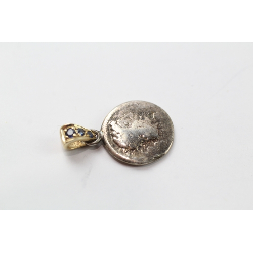 456 - A silver coin mounted with a 9ct gold and sapphire set bail (1.9g)