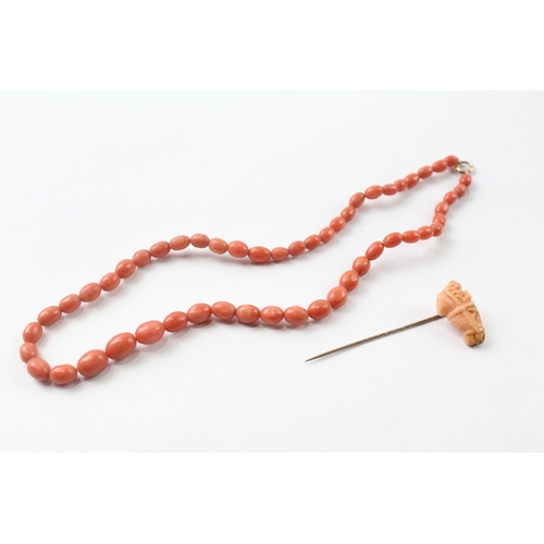 483 - 9ct gold clasped coral bead necklace and a carved coral stick pin (17.4g)