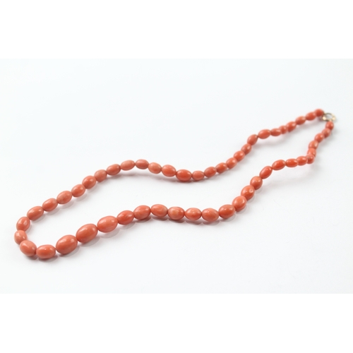 483 - 9ct gold clasped coral bead necklace and a carved coral stick pin (17.4g)