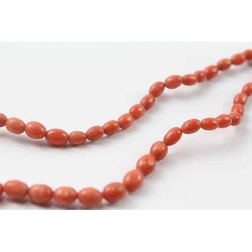 483 - 9ct gold clasped coral bead necklace and a carved coral stick pin (17.4g)