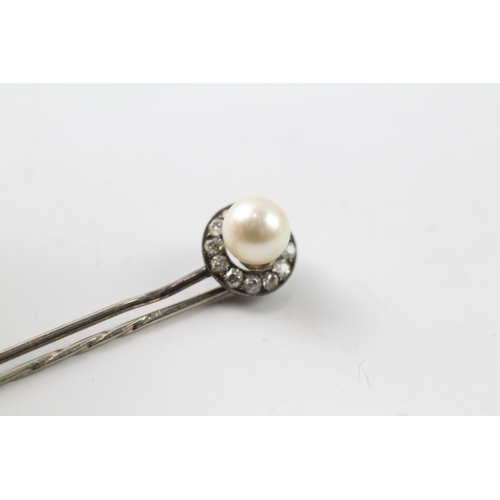 509 - Two stick pins, one silver and diamond set the other a 9ct gold head (2.6g)