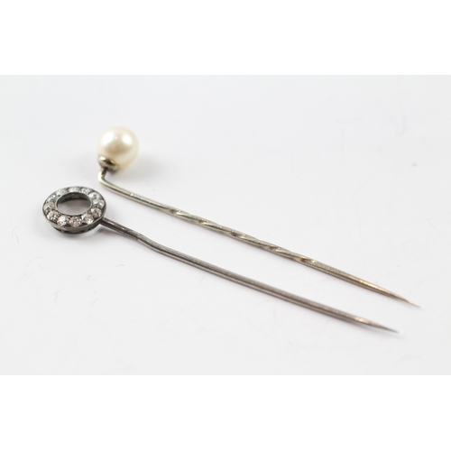 509 - Two stick pins, one silver and diamond set the other a 9ct gold head (2.6g)