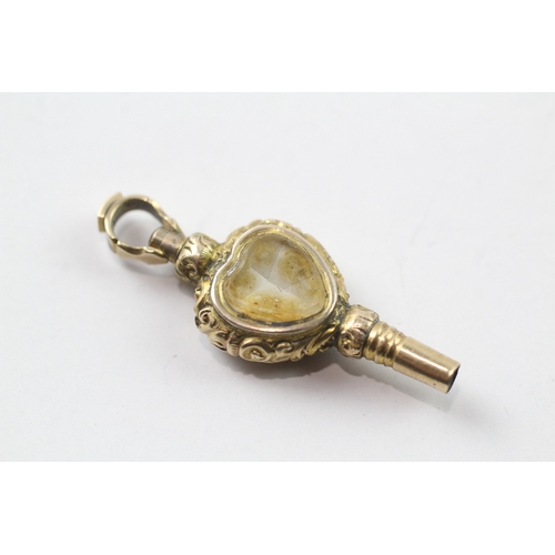 515 - 9ct gold cased watch key fob set with chalcedony and a glass panel (2.9g)