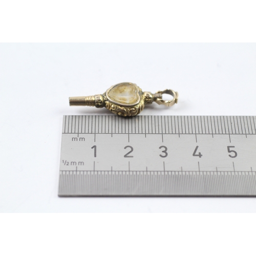 515 - 9ct gold cased watch key fob set with chalcedony and a glass panel (2.9g)