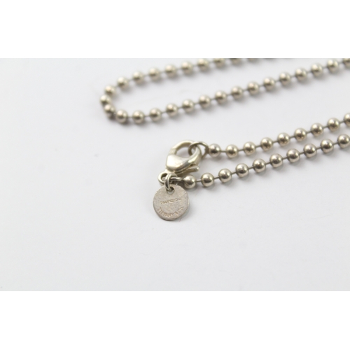 565 - A silver chain and two pendants by Tiffany and Co (19g)