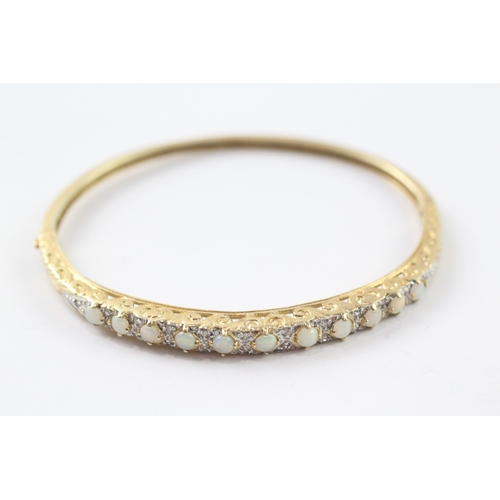 65 - 9ct gold opal and diamond set bangle (9.9g)