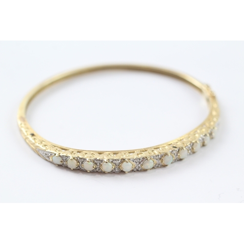 65 - 9ct gold opal and diamond set bangle (9.9g)