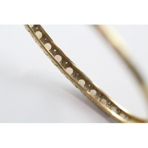 65 - 9ct gold opal and diamond set bangle (9.9g)