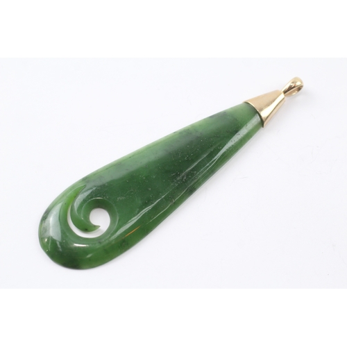 77 - 9ct gold carved nephrite pendant (20.2g)