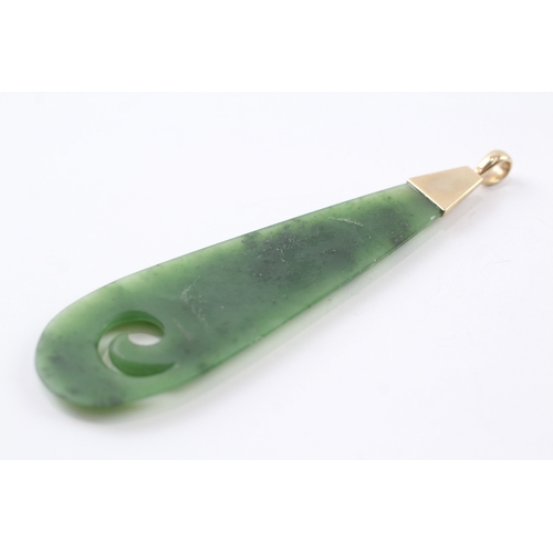 77 - 9ct gold carved nephrite pendant (20.2g)