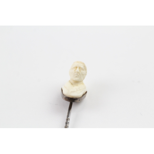 94 - 9ct gold carved figural stick pin (2.3g)