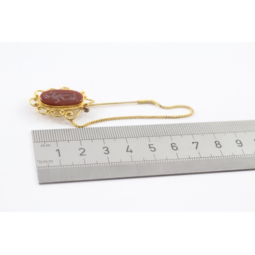 98 - 18ct gold carved carnelian stick pin (5.7g)