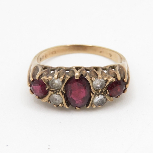 215 - 9ct gold garnet and white gemstone gypsy set ring (3.8g) Size O 1/2