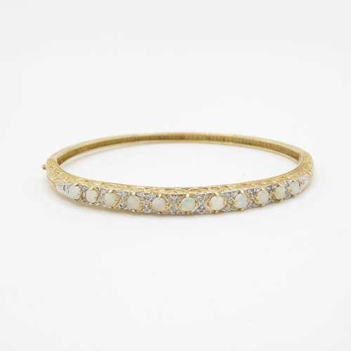 65 - 9ct gold opal and diamond set bangle (9.9g)