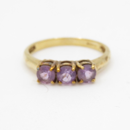 94 - 9ct gold amethyst three stone ring (2.1g) Size N 1/2