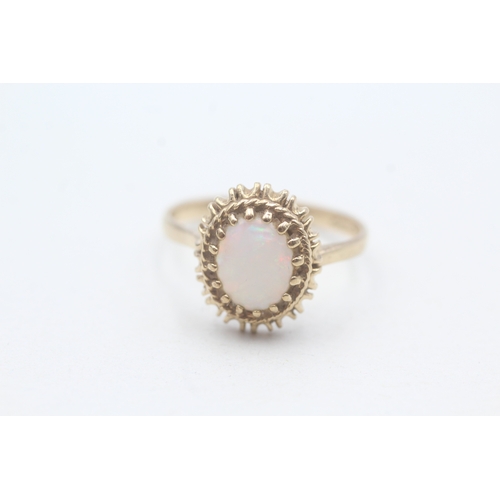 185 - 9ct gold opal framed ring (2.7g) Size P