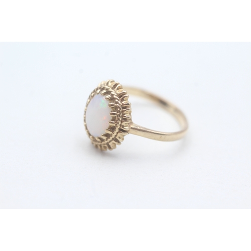 185 - 9ct gold opal framed ring (2.7g) Size P