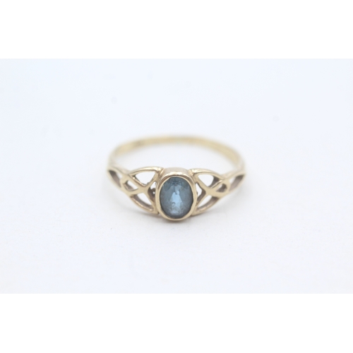 190 - 9ct gold blue topaz set Celtic dress ring (1.3g) Size M