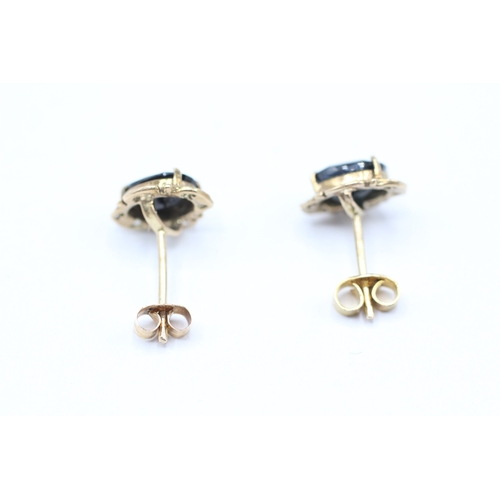 209 - 9ct gold oval cut sapphire set stud earrings (1.4g)