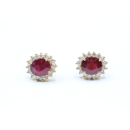 229 - 18ct gold diamond & glass filled ruby oval cluster stud earrings (5.6g)