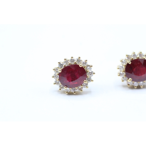 229 - 18ct gold diamond & glass filled ruby oval cluster stud earrings (5.6g)