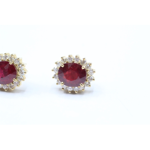 229 - 18ct gold diamond & glass filled ruby oval cluster stud earrings (5.6g)