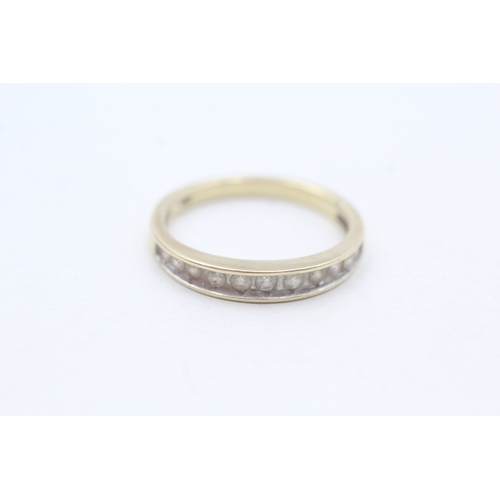 65 - 9ct gold diamond channel set ring (2.1g) Size O