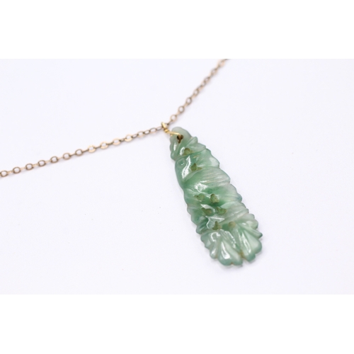 231 - 18ct gold carved jade pendant necklace with 9ct chain (3.5g)