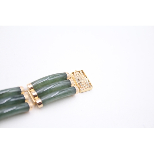 41 - 14ct gold jade bracelet with a Chinese symbol clasp (28.9g)