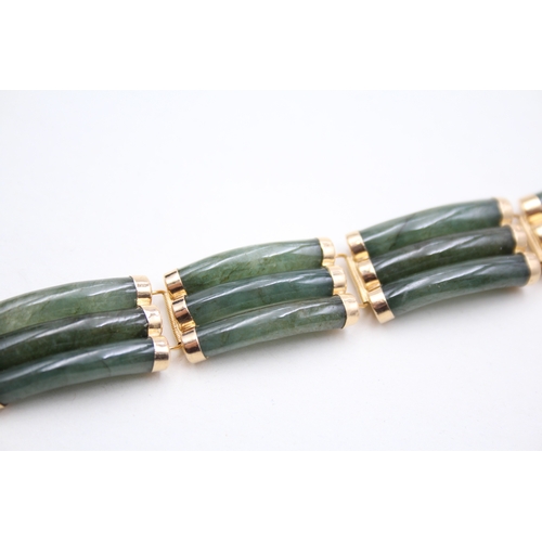 41 - 14ct gold jade bracelet with a Chinese symbol clasp (28.9g)