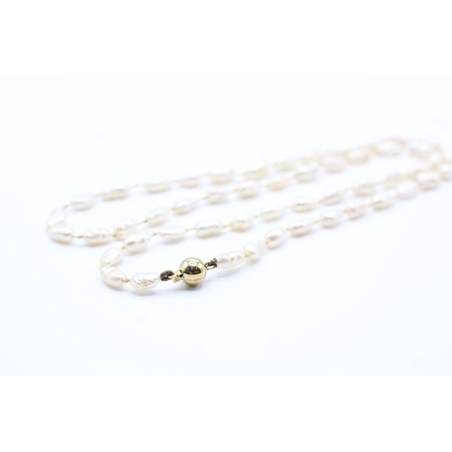 63 - 14ct gold rice pearl necklace (10.8g)