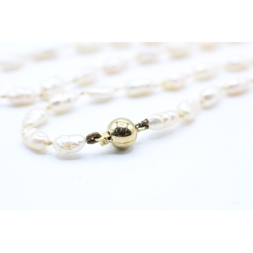 63 - 14ct gold rice pearl necklace (10.8g)