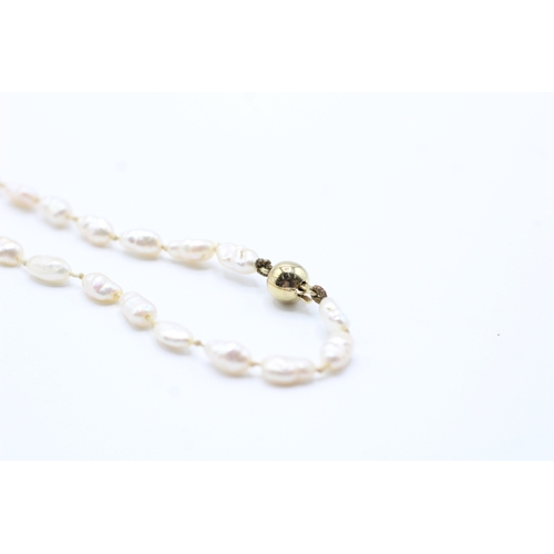 63 - 14ct gold rice pearl necklace (10.8g)