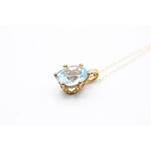 92 - 9ct gold oval cut blue gemstone & diamond pendant necklace (2.4g)